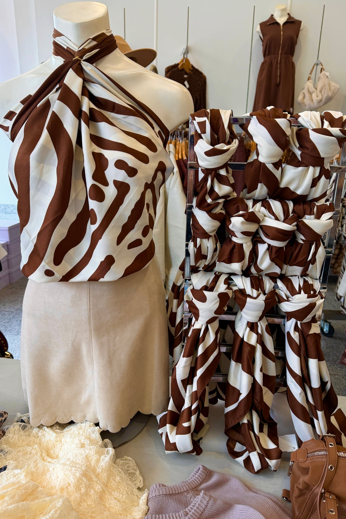 Large tiger print scarves styled as tops on display