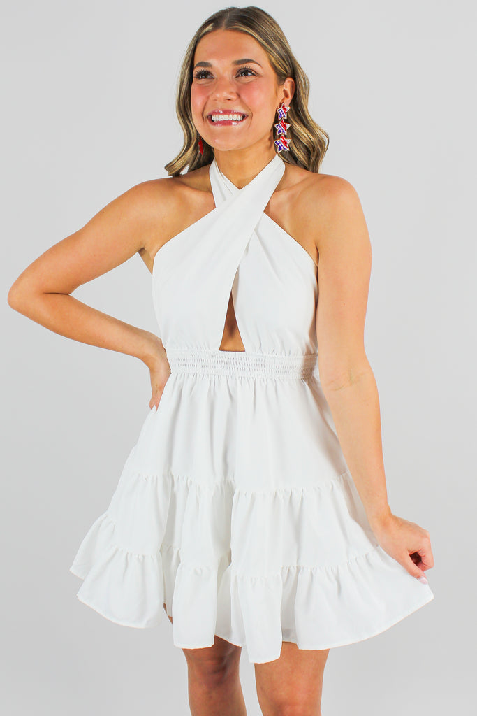 white tiered dress with criss cross halter neck