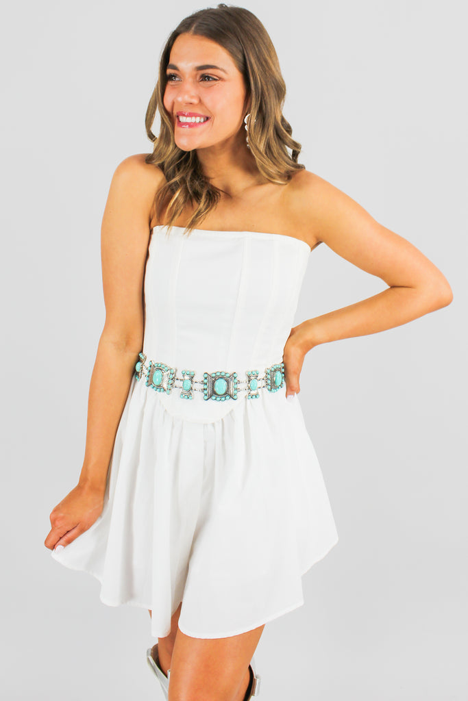 white corset dress with a fitted top and a flowy bottom.