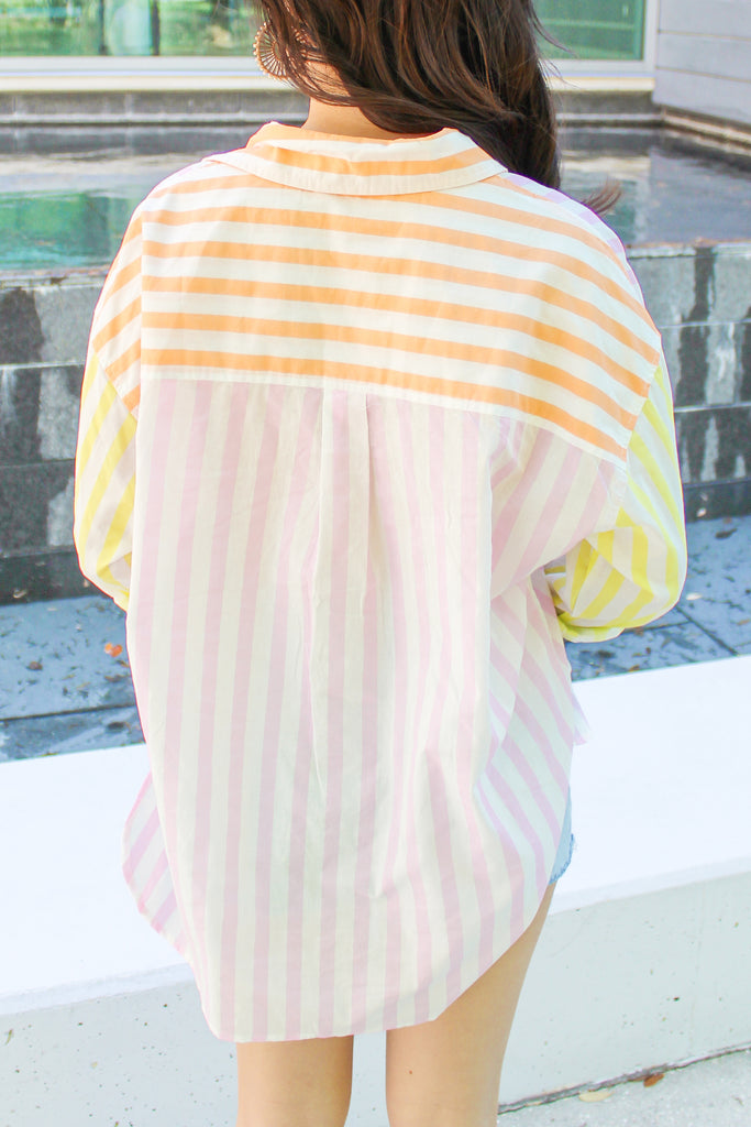 orange, pink and yellow striped button up top with a front pocket