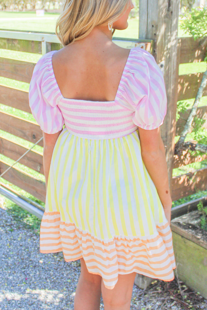 pink, orange, and yellow striped tiered puff sleeve dress