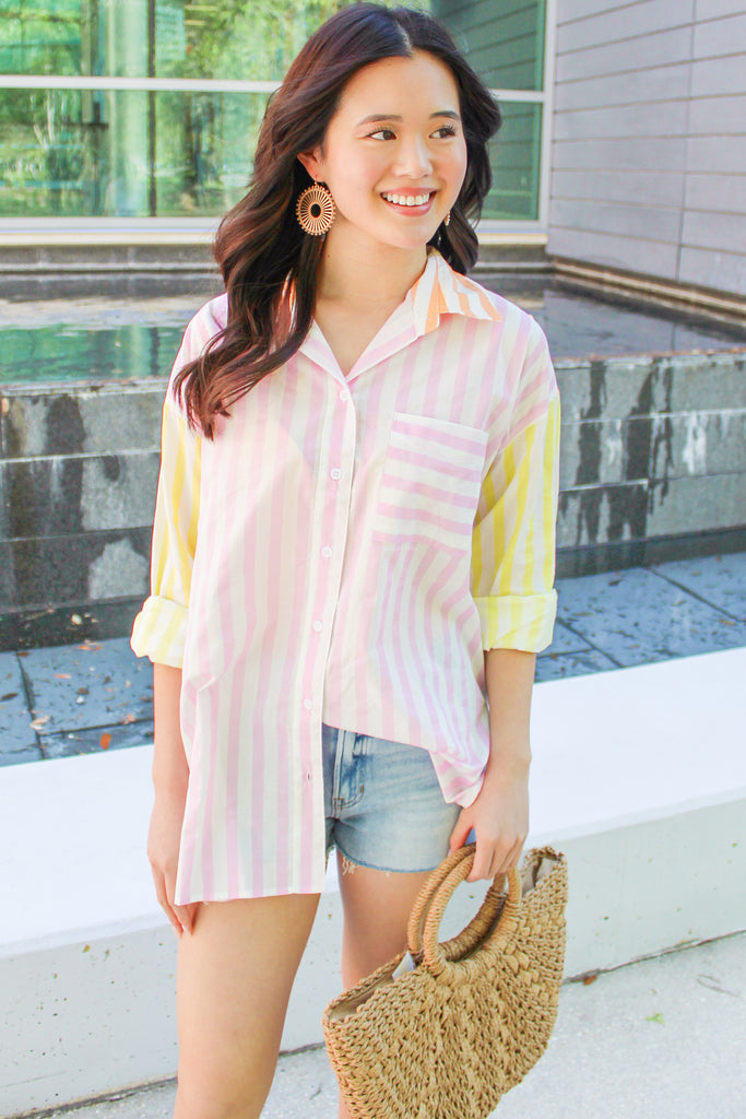orange, pink and yellow striped button up top with a front pocket