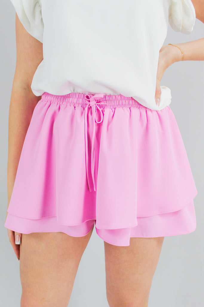 Light pink/purple drawstring, cinched-waist skort with a ruffle overlay