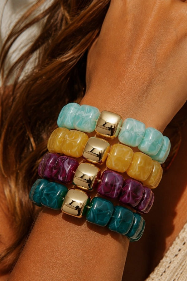 Acrylic Gems Gold Ball Bracelets stacked on a wrist