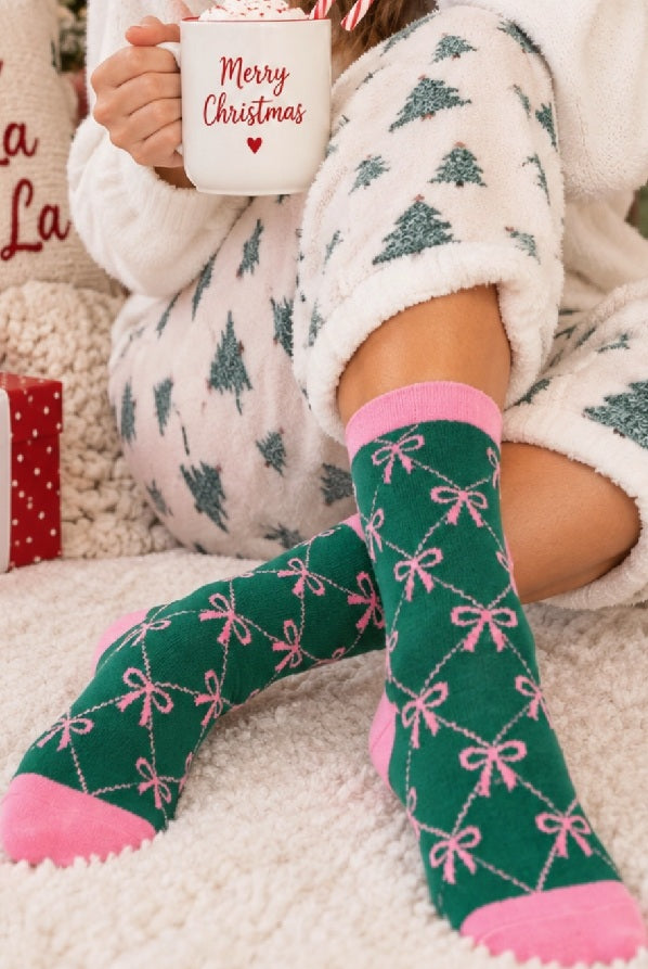 Feeling Fuzzy Bow Socks in Green worn with Christmas pajamas