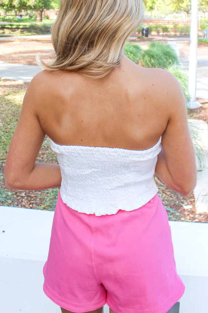 white strapless denim tube top that buttons down the front and has a smocked stretchy back