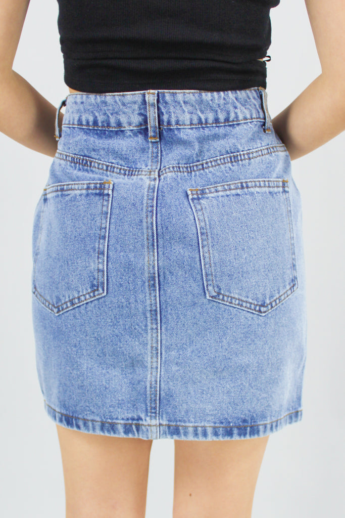 back view of medium denim rhinestone embellished mini skirt