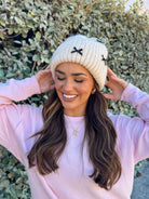 Cream knit beanie with black bows