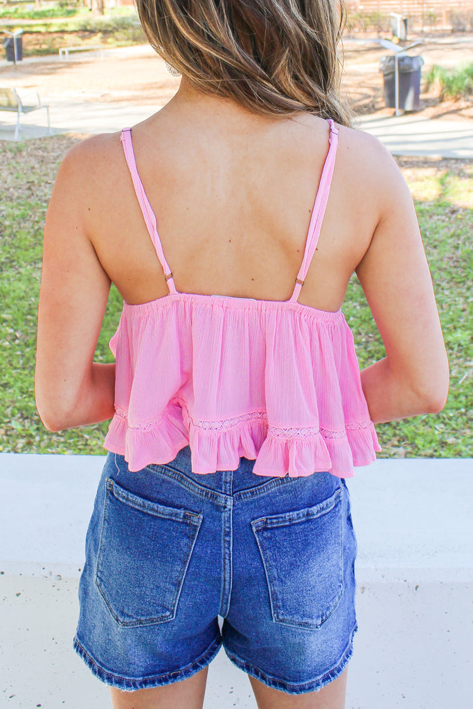 light pink flowy v-neck tank with a tie detail under the bust and crochet trim 