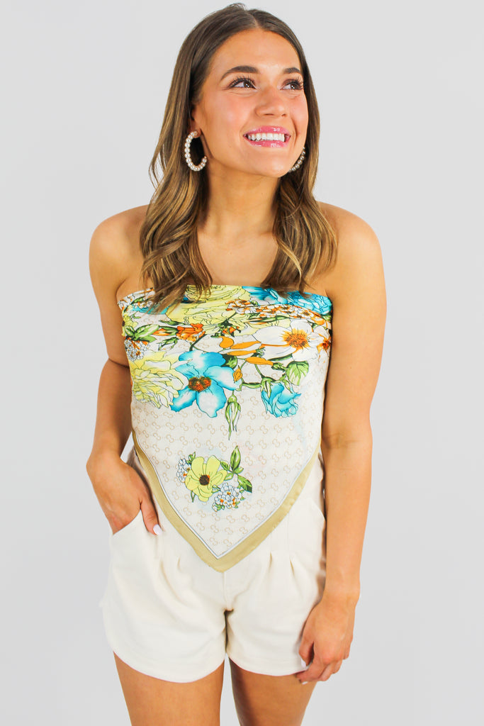 light brown floral silk scarf worn as a top, tied in the back