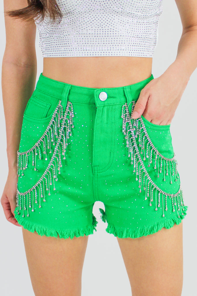 green denim shorts with rhinestone fringe detail along the front.