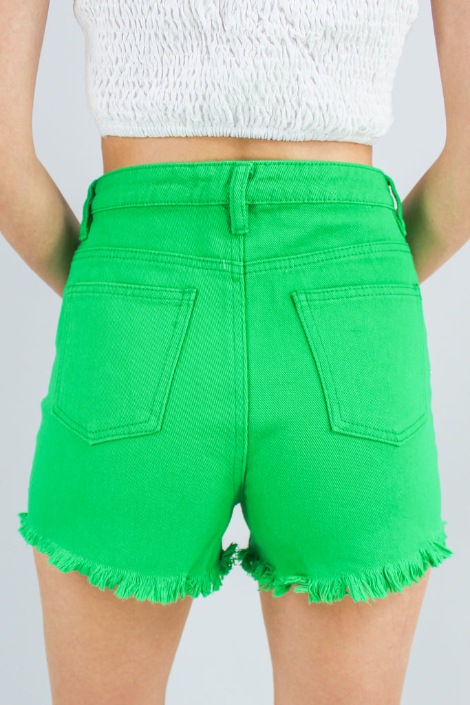 green denim shorts with rhinestone fringe detail along the front.