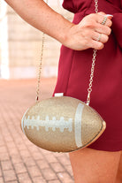 Gold rhinestone football clutch bag