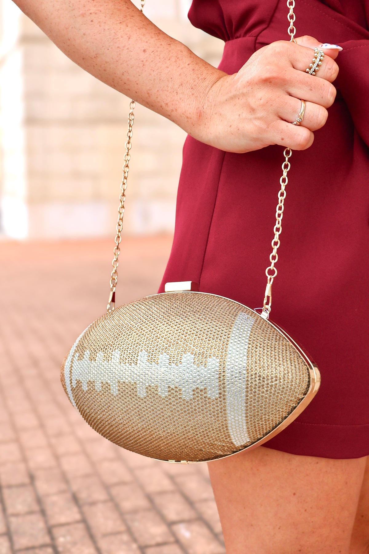 Gold rhinestone football clutch bag