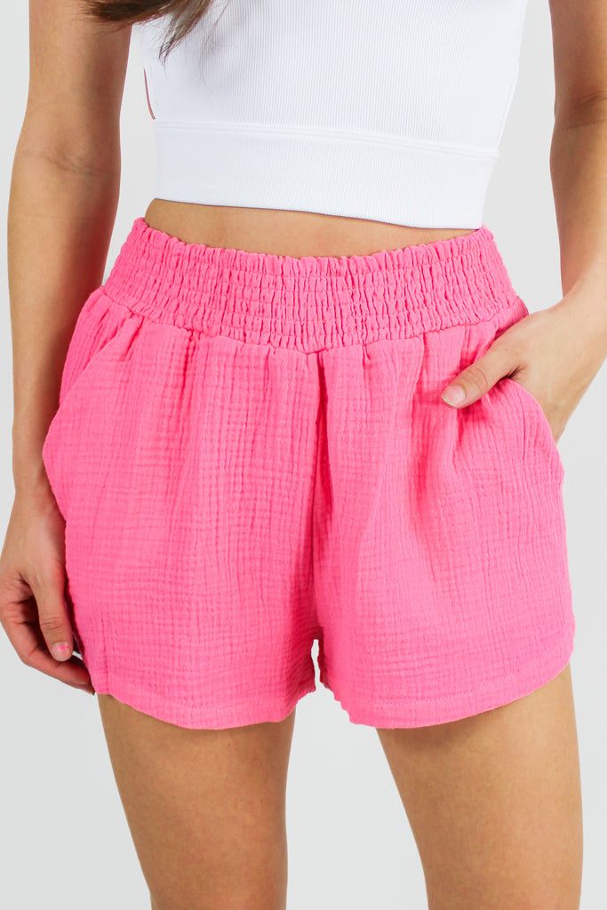 front view of pink gauze shorts with a smocked waist