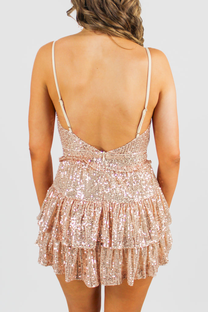 rose gold sequin romper with adjustable straps and a tiered ruffle skort with a smocked waistst