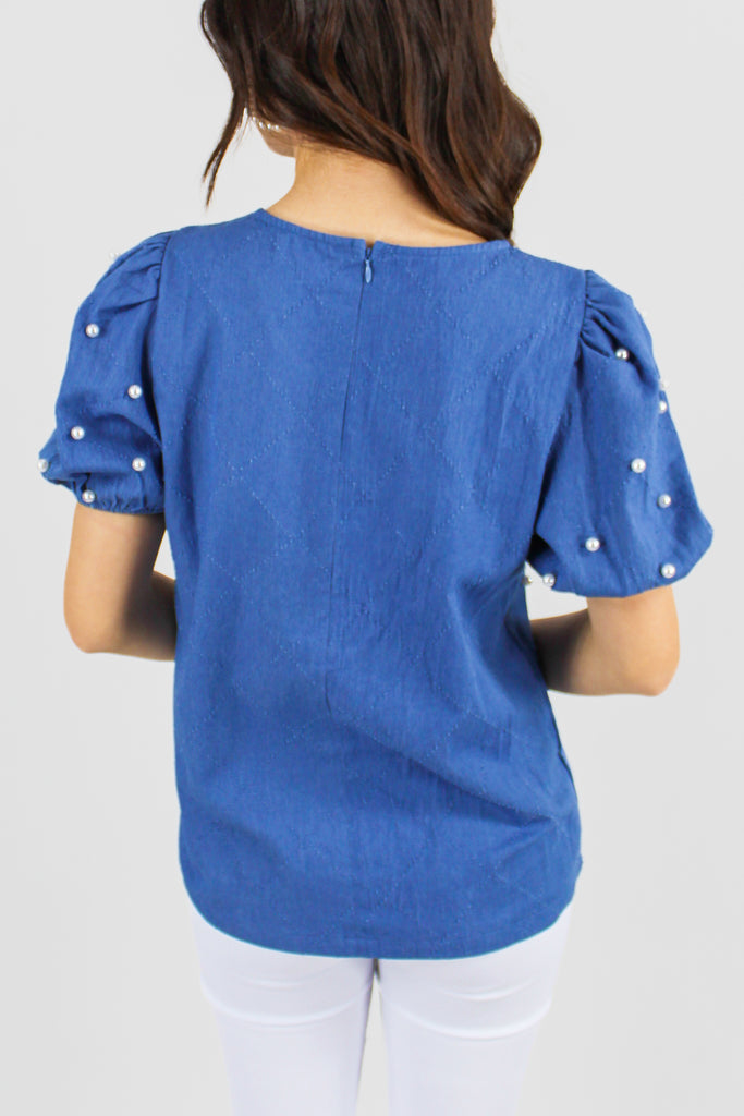 medium denim puff sleeve top with pearl embellishments throughout