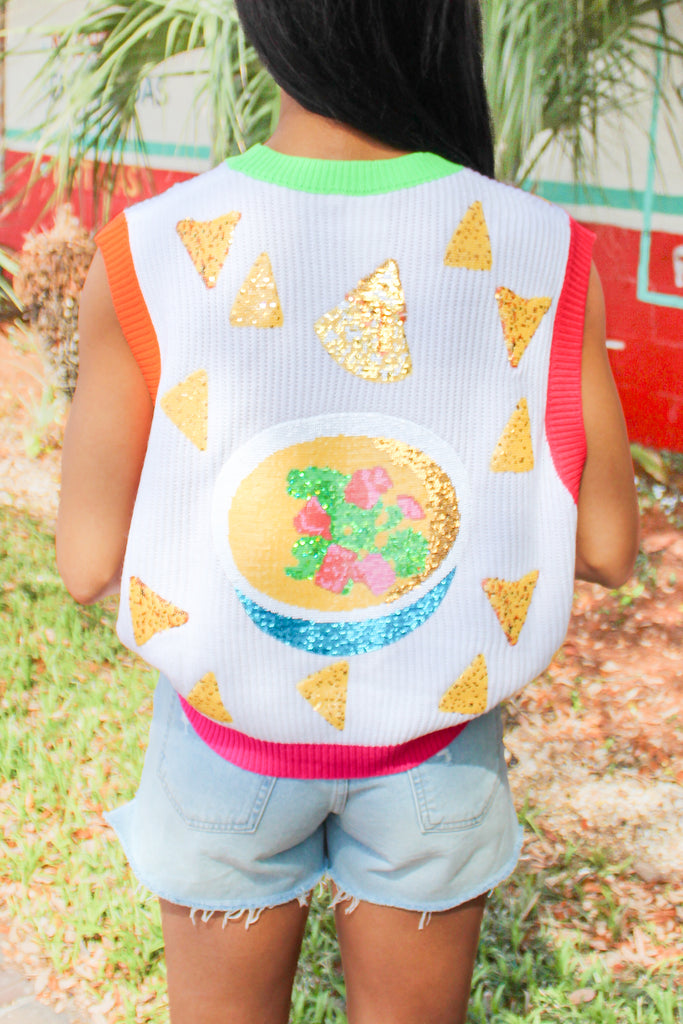 white sweater vest with sequin chips and tinsel lettering