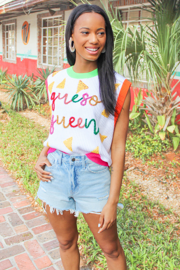 white sweater vest with sequin chips and tinsel lettering 