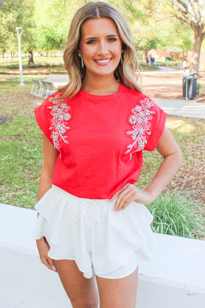 red cotton tank with cuffed sleeves and an embroidered and beaded detail on the shoulders