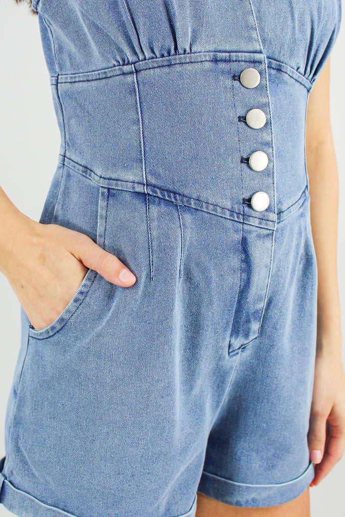 collared denim romper with a cuffed hem and 4 buttons in the front