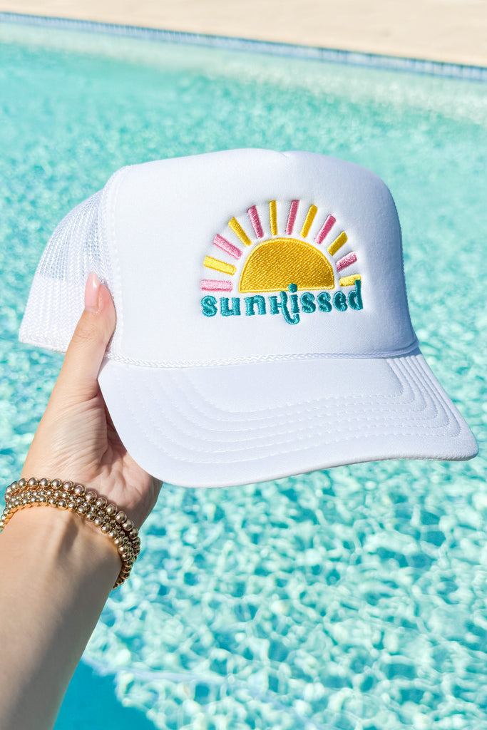 white snapback trucker hat with sunkissed embroidered on the front