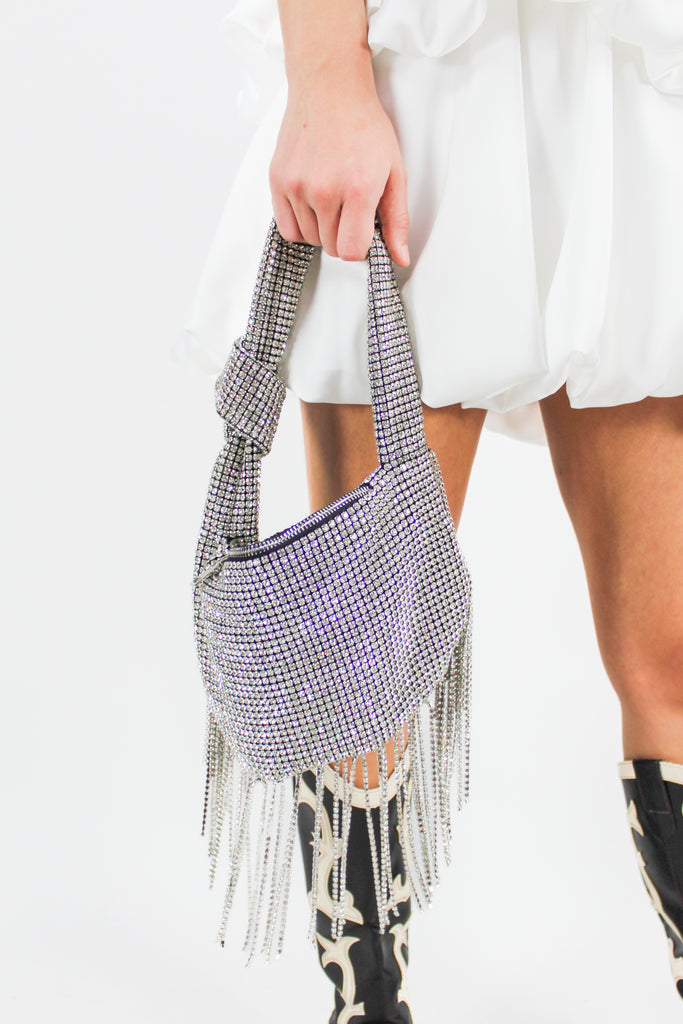 rhinestone shoulder bag with fringe on the bottom and a knot in the handle