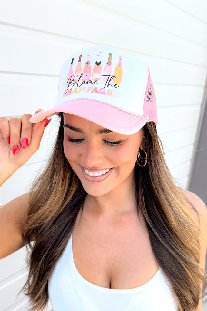 blame the champagne trucker hat
