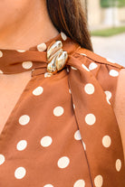 Caramel polka dot brooch detail top, close-up