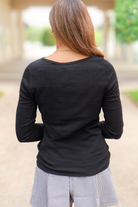 Black fitted ribbed long sleeve top, back view