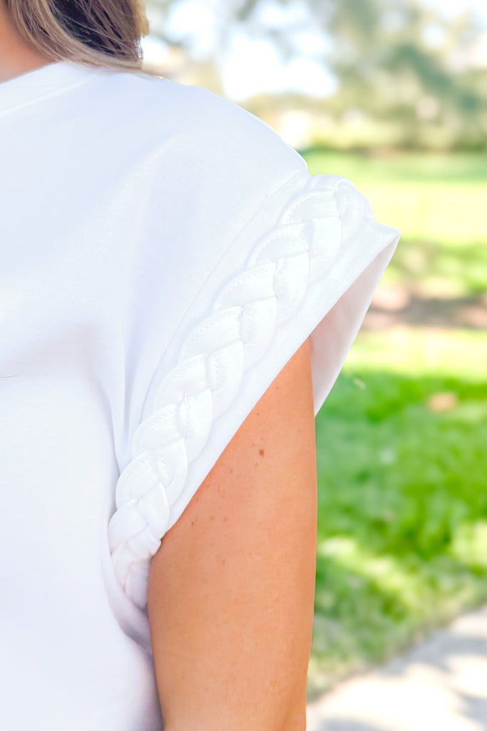 braided sleeve detail on white tee