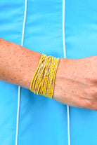 Set of fifteen black, white and gold beaded stretch bracelets