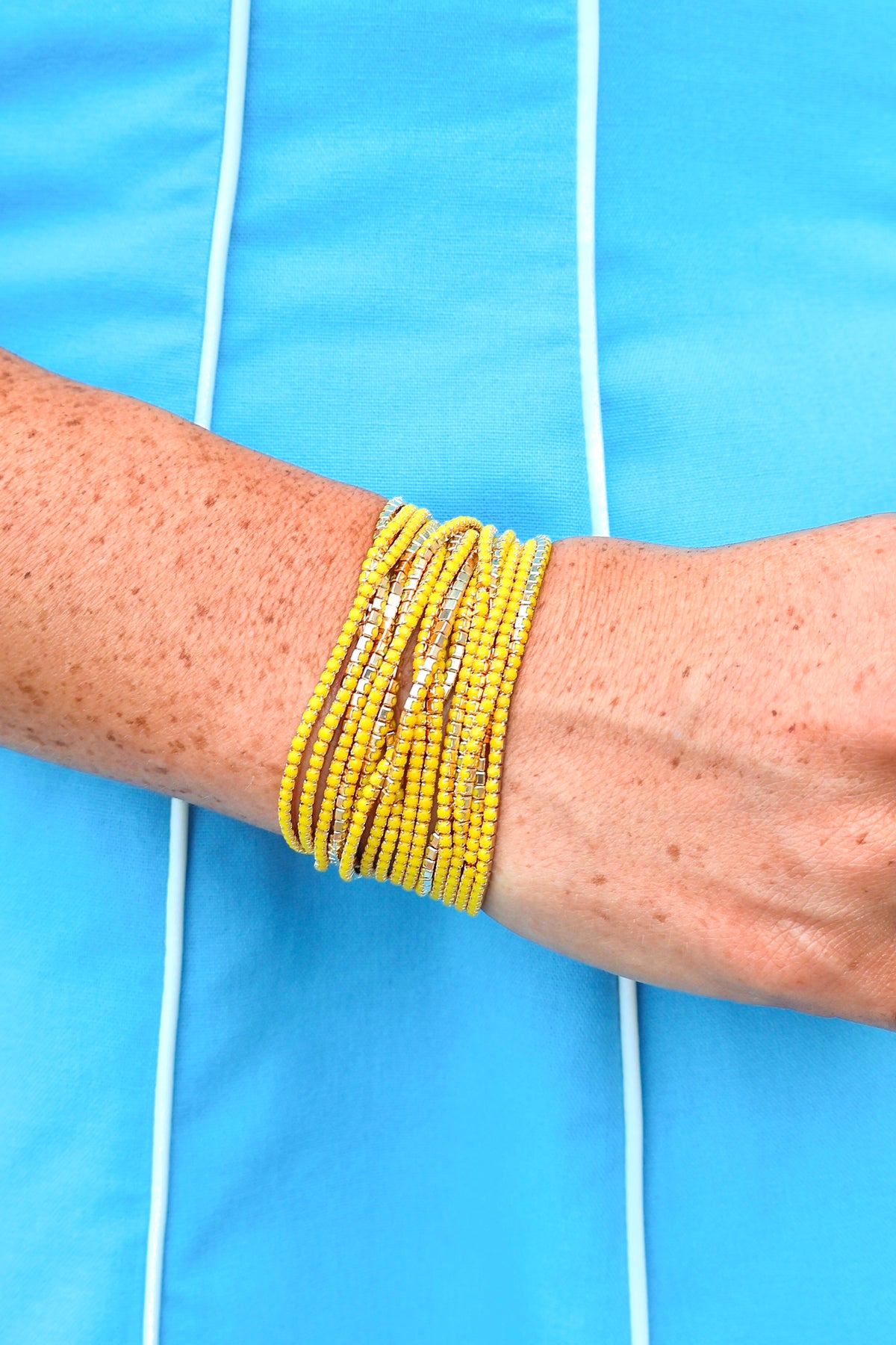 Set of fifteen black, white and gold beaded stretch bracelets