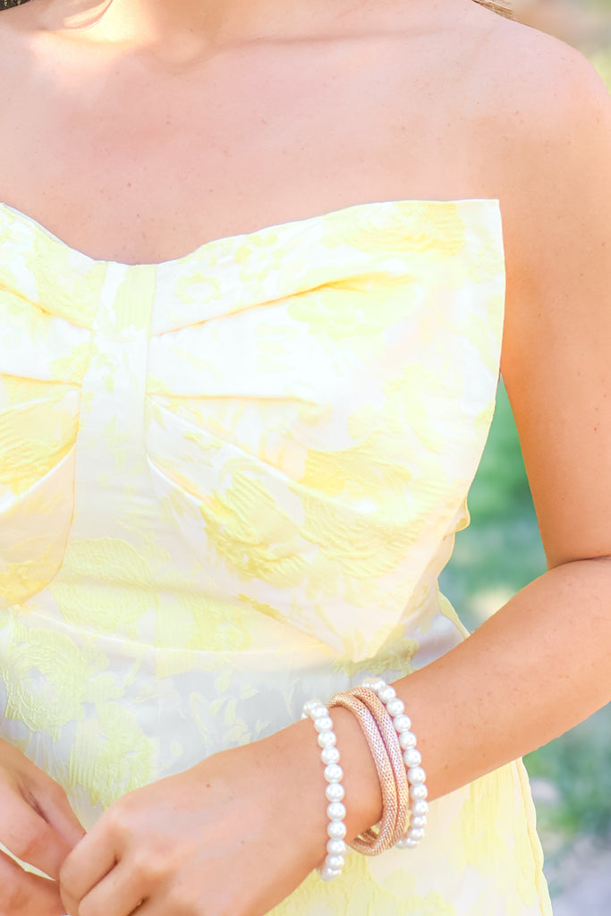 up close of bow on floral light yellow romper
