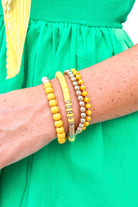 Set of four purple and gold beaded stretch bracelets