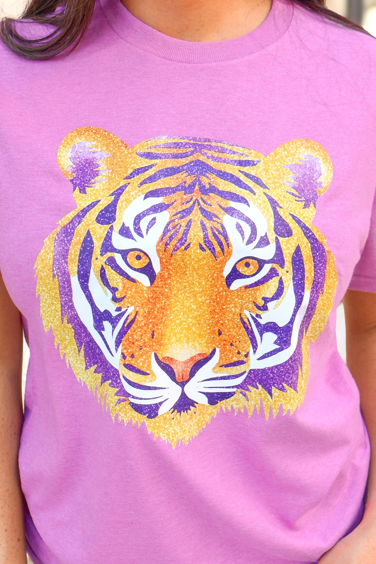 Close-up of the glitter tiger graphic on the heather lilac tee