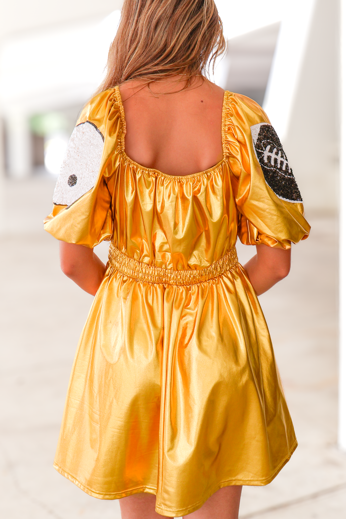back of metallic puff sleeve dress in gold