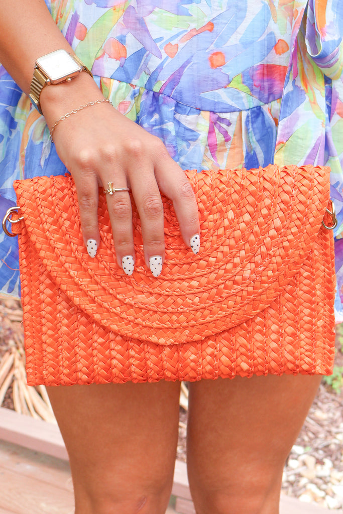 orange woven clutch