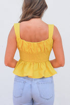 back of yellow peplum top