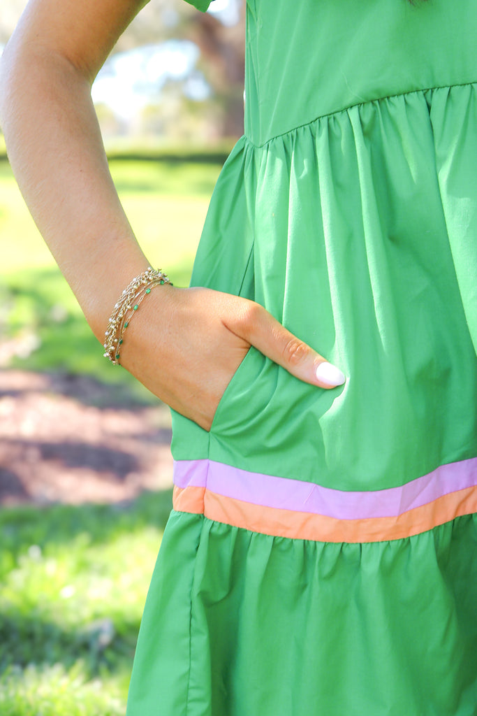 pocket of green tiered puff sleeve dress